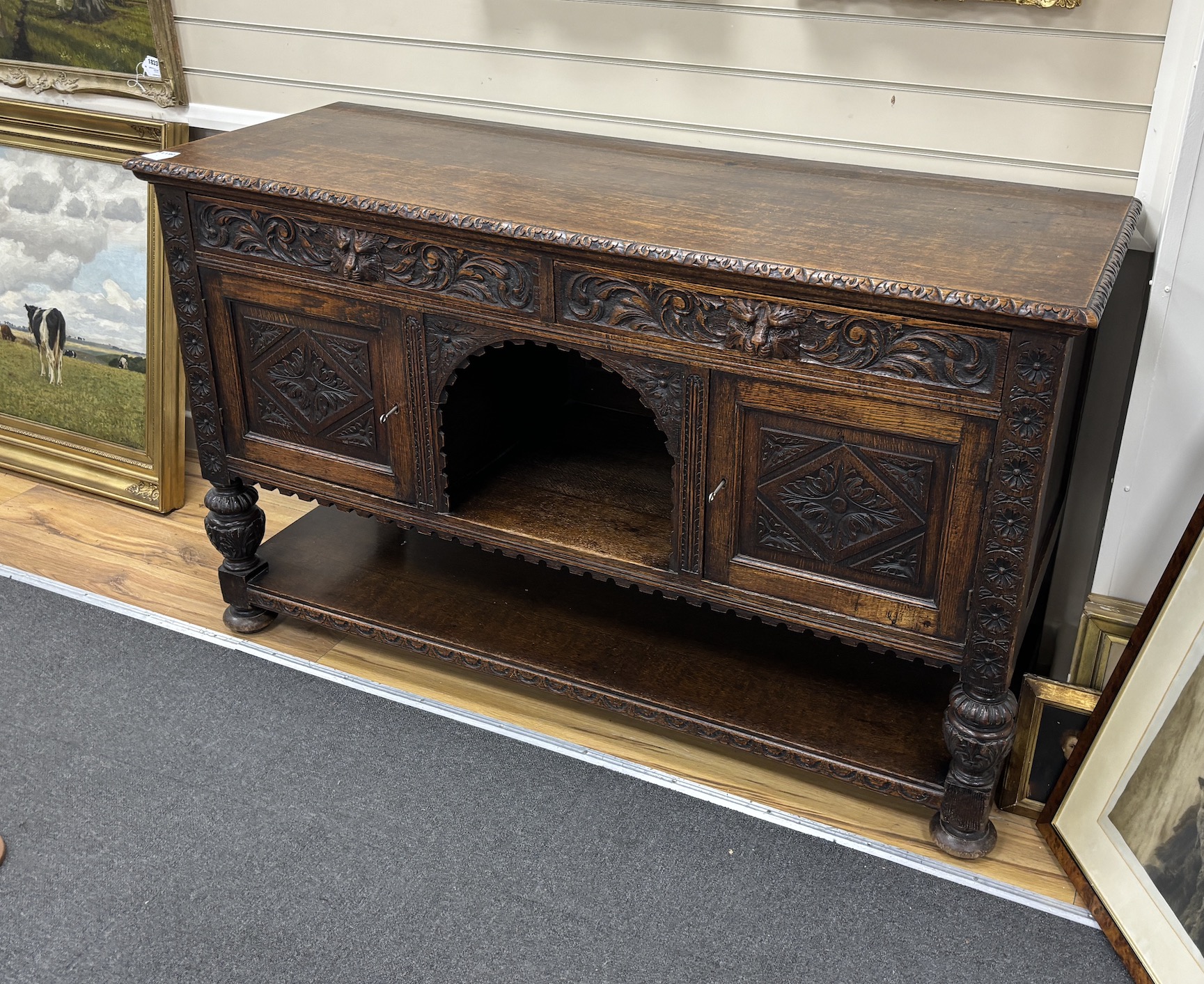 A late 19th century Flemish carved oak sideboard, length 152cm, depth 55cm, height 92cm